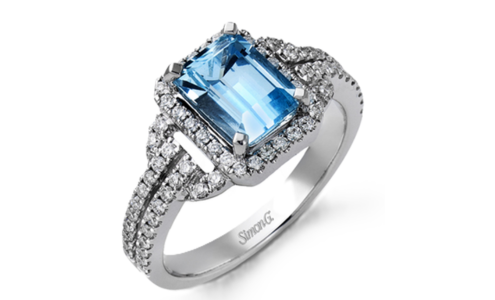 A close-up of an ornate Simon G. engagement ring with an aquamarine centre stone, available at Nash Jewellers.
