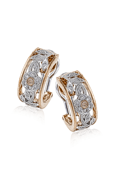 A rose and white gold ornate earrings.