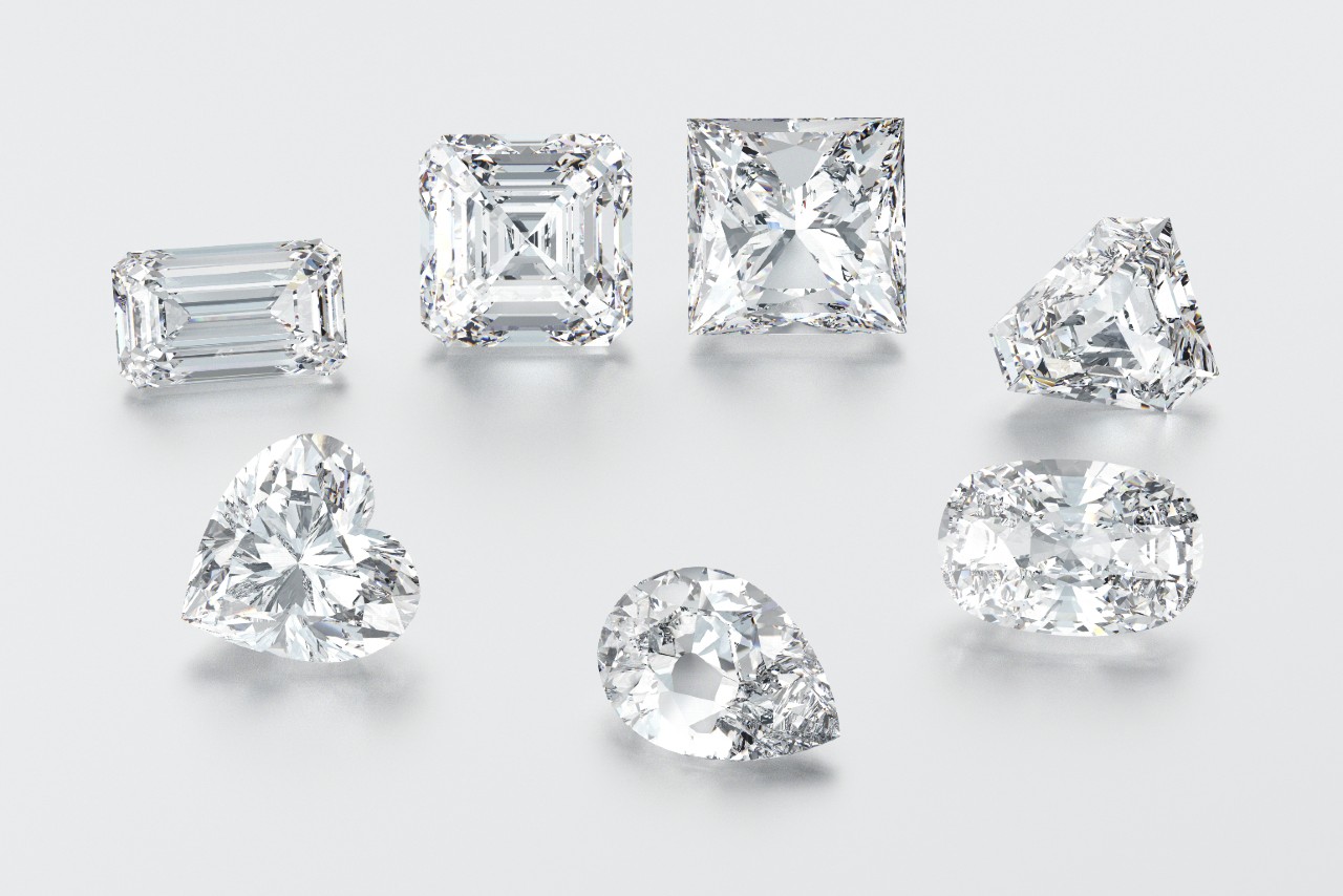 Various diamond cuts displayed on a light background: emerald, asscher, princess, trillion, heart, pear, and oval.