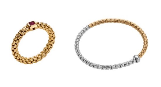 a yellow gold and ruby FOPE ring next to a mixed metal FOPE bracelet