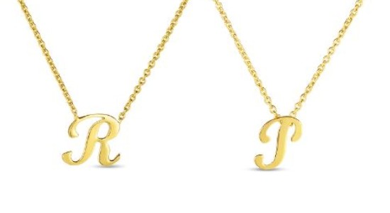 two matching yellow gold initial necklaces–one with an R and one with a P