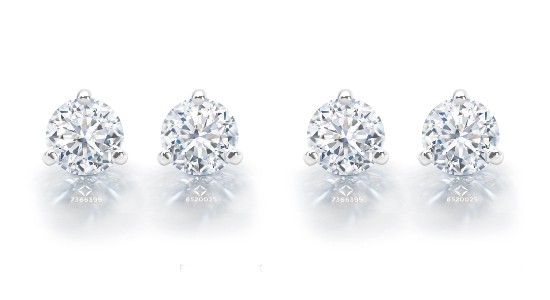 two identical pairs of diamond stud earrings