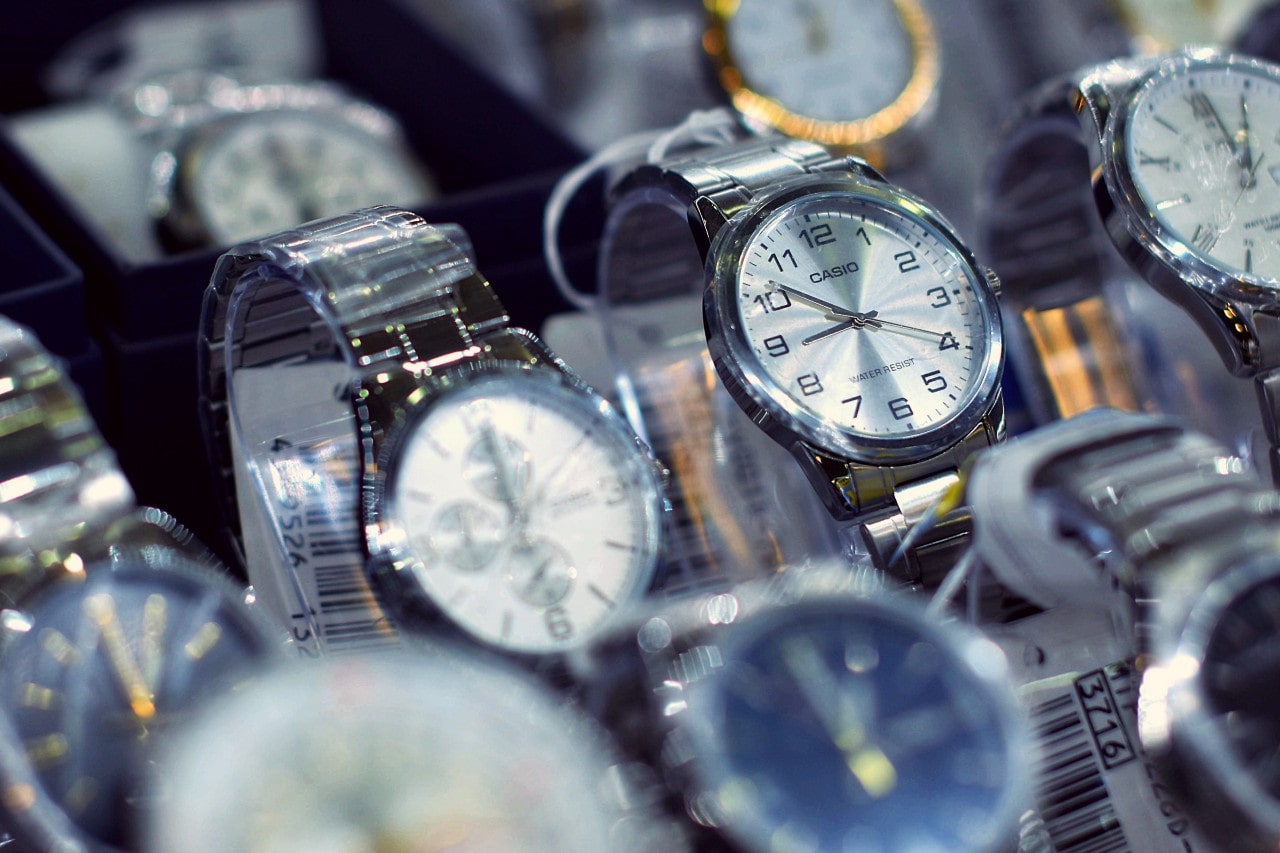 A collection of silver wristwatches displayed in a store, with a Casio watch in focus.