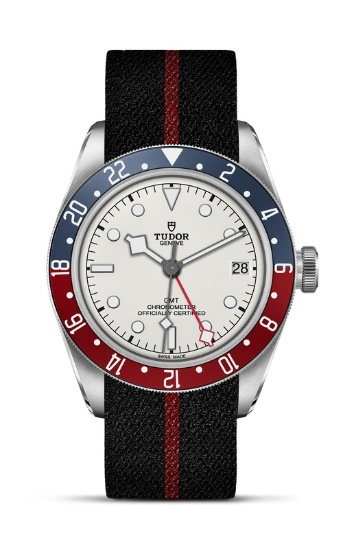 A TUDOR watch with white dial, two colour rotating bezel and a black and red fabric bracelet