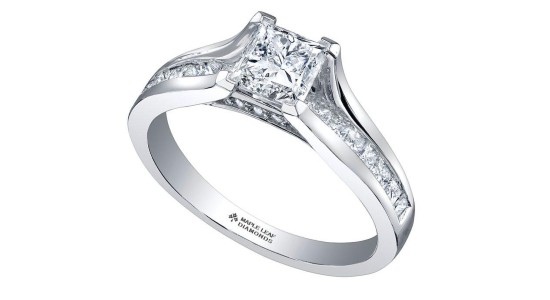 a silver engagement ring with a princess cut centre stone and elegant side stones
