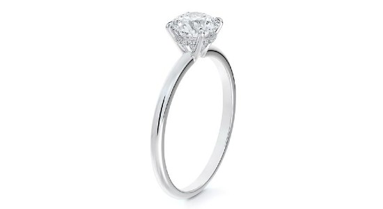 a silver engagement ring featuring a round centre stone and a hidden halo