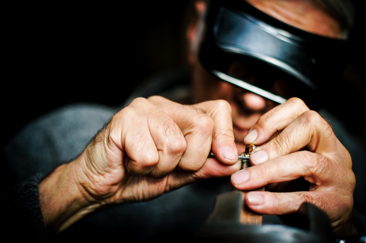 A close-up of a jeweller working on a ring.